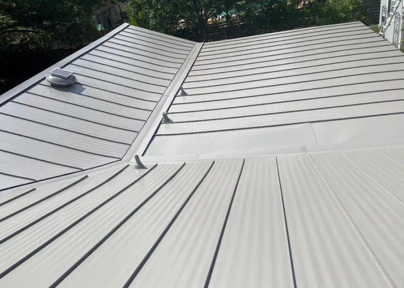 Solar attic fan installed on a metal roof for Roof Ventilation in Eugene